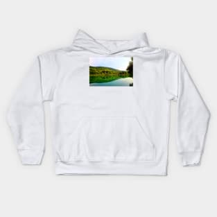 Classic panorama with Marche hilly landscape, emerald waters of the lake, tree silhouette and lush vegetation Kids Hoodie